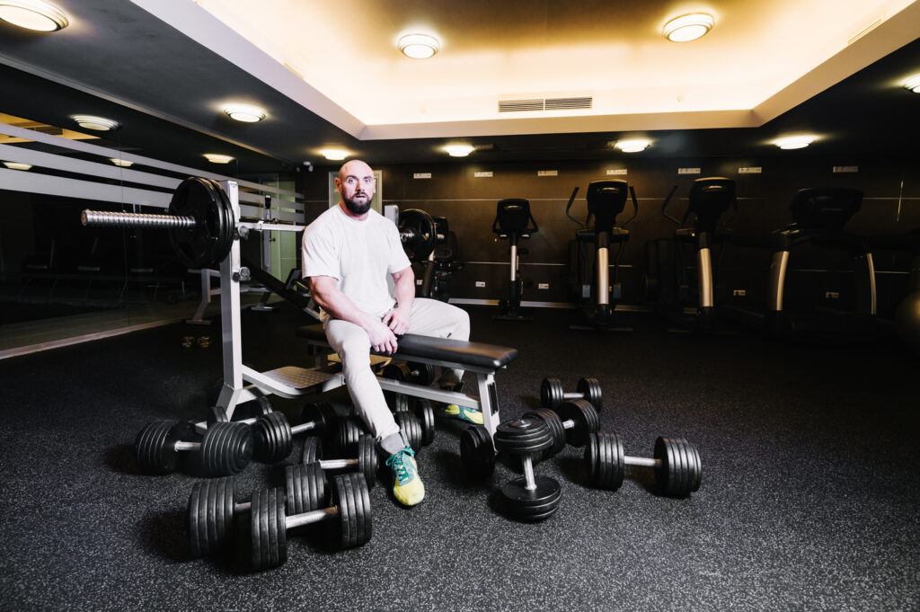 a person doing heavy weight-lifting in gym